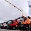 Рядом с краном в ряд выставлены грузовики Hongyan - совместный проект итальянской компании IVECO и китайского автомобильного концерна SAIC MOTOR — newsvl.ru